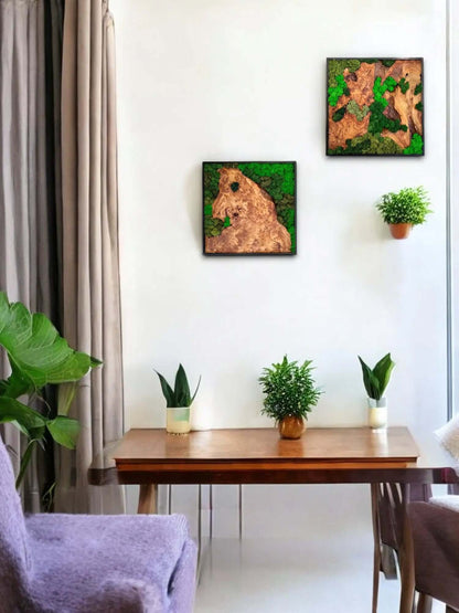 Two moss wall art pieces of cedar wood displayed in a modern interior with a wooden table and green plants